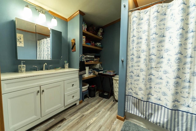 277 James St, Tomah, WI 54660 - full bath with wood finished floors, crown molding, curtained shower, and vanity