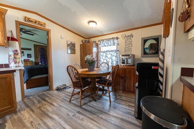 277 James St, Tomah, WI 54660 - dining space with lofted ceiling, crown molding, and wood finished floors