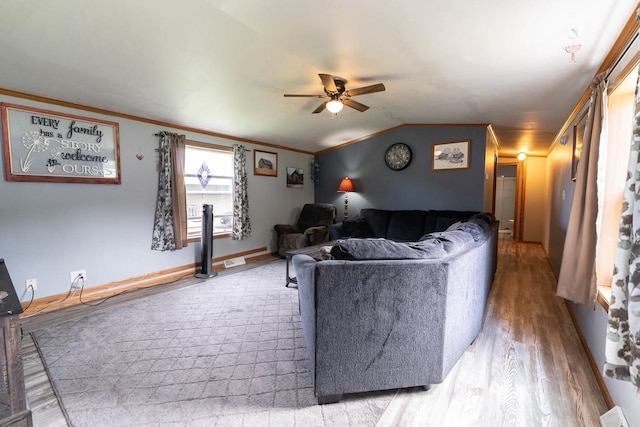277 James St, Tomah, WI 54660 - living room featuring a ceiling fan, light wood finished floors, ornamental molding, vaulted ceiling, and baseboards