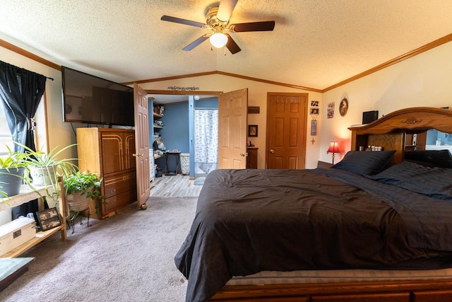 277 James St, Tomah, WI 54660 - carpeted bedroom with lofted ceiling, a textured ceiling, ornamental molding, and ceiling fan