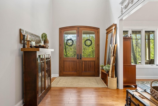 1521 Geneva Club Dr Unit 18-05, Lake Geneva, WI 53147 - entrance foyer with french doors, healthy amount of natural light, hardwood / wood-style floors, baseboards, and a towering ceiling