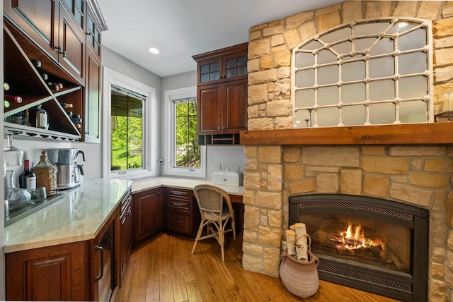 1521 Geneva Club Dr Unit 18-05, Lake Geneva, WI 53147 - bar area featuring light wood finished floors and a stone fireplace
