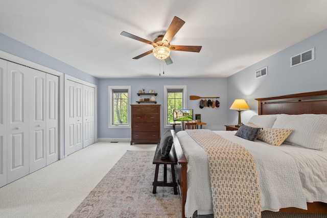 1521 Geneva Club Dr Unit 18-05, Lake Geneva, WI 53147 - bedroom featuring multiple closets, carpet floors, ceiling fan, and baseboards