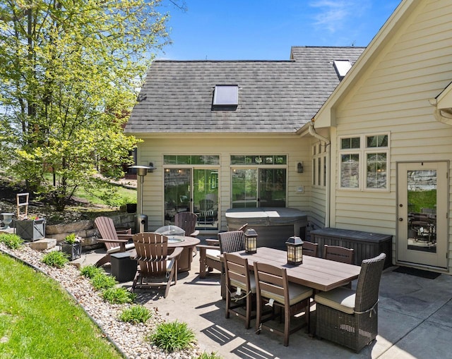 1521 Geneva Club Dr Unit 18-05, Lake Geneva, WI 53147 - view of patio / terrace with a hot tub and outdoor dining space