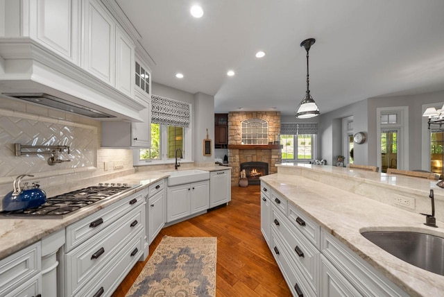 1521 Geneva Club Dr Unit 18-05, Lake Geneva, WI 53147 - kitchen with a sink, a stone fireplace, white cabinetry, and recessed lighting