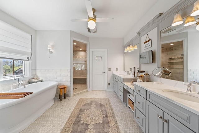 1521 Geneva Club Dr Unit 18-05, Lake Geneva, WI 53147 - bathroom featuring a shower stall, ceiling fan, vanity, a freestanding tub, and tile walls