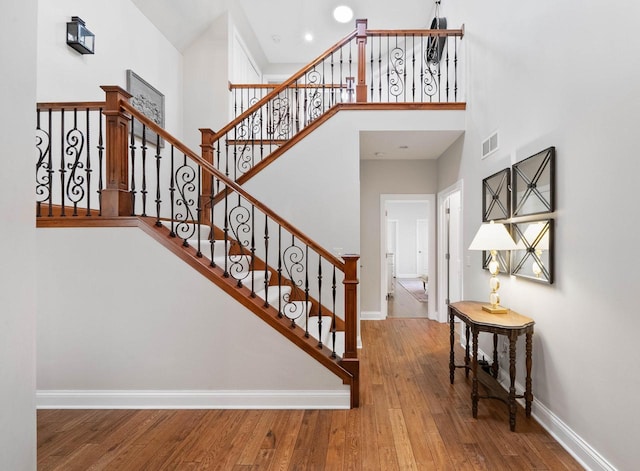 1521 Geneva Club Dr Unit 18-05, Lake Geneva, WI 53147 - stairway with baseboards, a high ceiling, and wood finished floors