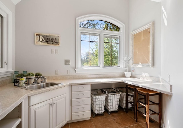 1521 Geneva Club Dr Unit 18-05, Lake Geneva, WI 53147 - interior space featuring white cabinets, a sink, tile patterned floors, and light countertops