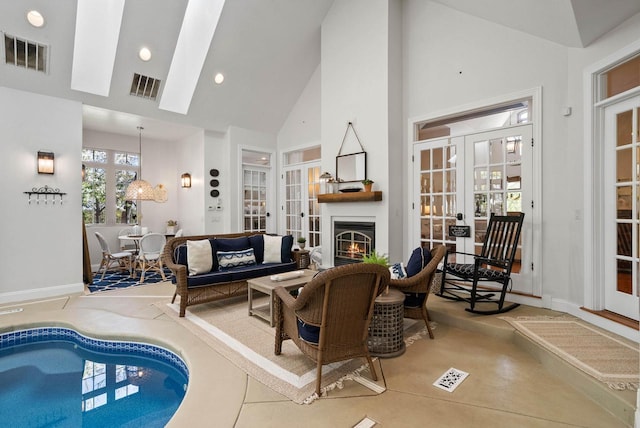 1521 Geneva Club Dr Unit 18-05, Lake Geneva, WI 53147 - living room featuring french doors, high vaulted ceiling, a lit fireplace, recessed lighting, and baseboards