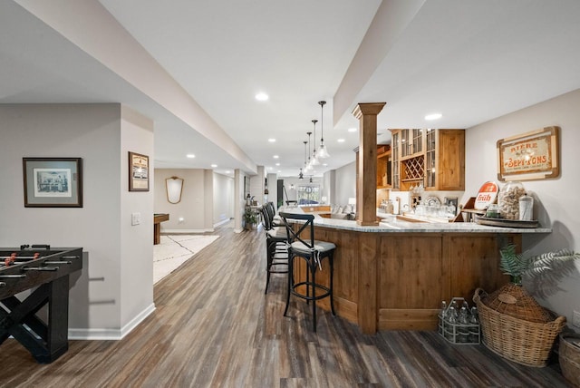 1521 Geneva Club Dr Unit 18-05, Lake Geneva, WI 53147 - indoor bar with dark wood finished floors, baseboards, recessed lighting, ornate columns, and pendant lighting