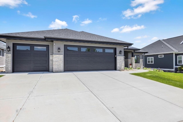 802 Lynn St, Waunakee, WI 53597 - prairie-style house with stone siding, concrete driveway, a garage, and a shingled roof