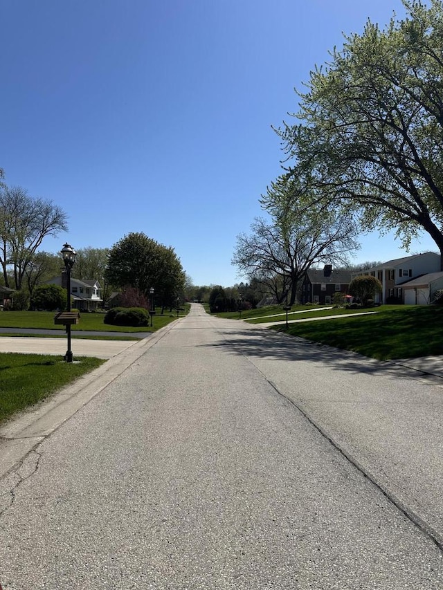 view of asphalt street with street lighting