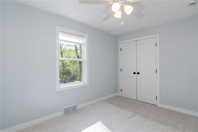 504 Wisconsin Ave, Frederic, WI 54837 - unfurnished bedroom featuring carpet flooring, a closet, baseboards, and a ceiling fan