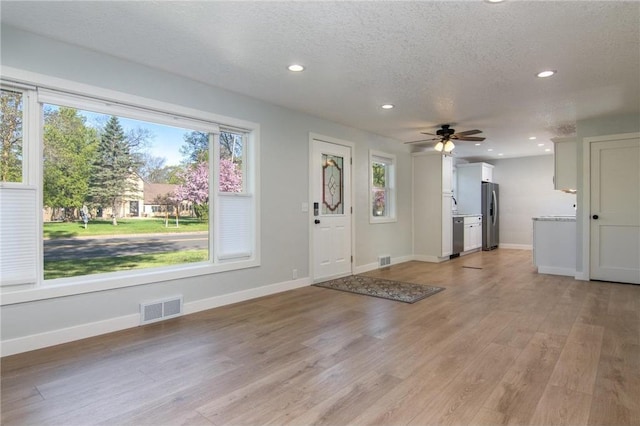 504 Wisconsin Ave, Frederic, WI 54837 - foyer featuring recessed lighting, baseboards, light wood-type flooring, ceiling fan, and a textured ceiling