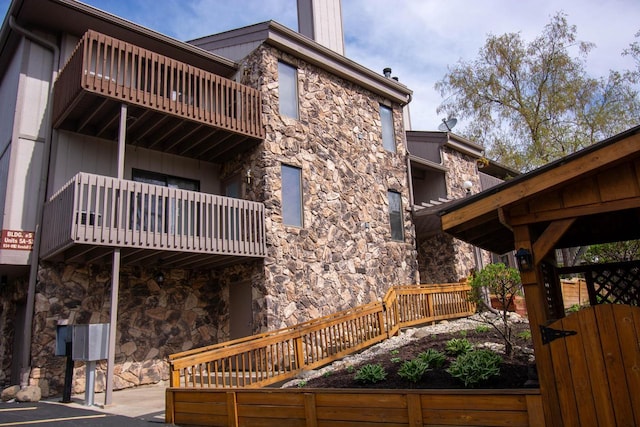 848 Kendall Ln Unit 5H, Lake Geneva, WI 53147 - rear view of property with a balcony and stone siding