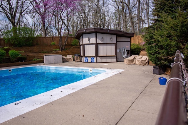 848 Kendall Ln Unit 5H, Lake Geneva, WI 53147 - view of swimming pool with a patio area, an outbuilding, a fenced backyard, and a storage shed
