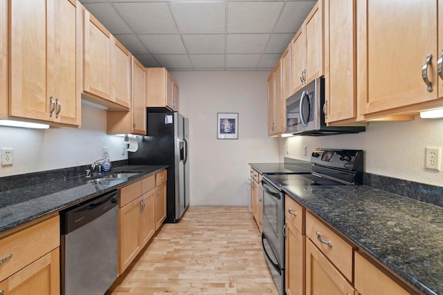 606 W Wisconsin Ave Unit 405, Milwaukee, WI 53203 - kitchen featuring stainless steel appliances, a sink, light wood finished floors, light brown cabinets, and a paneled ceiling