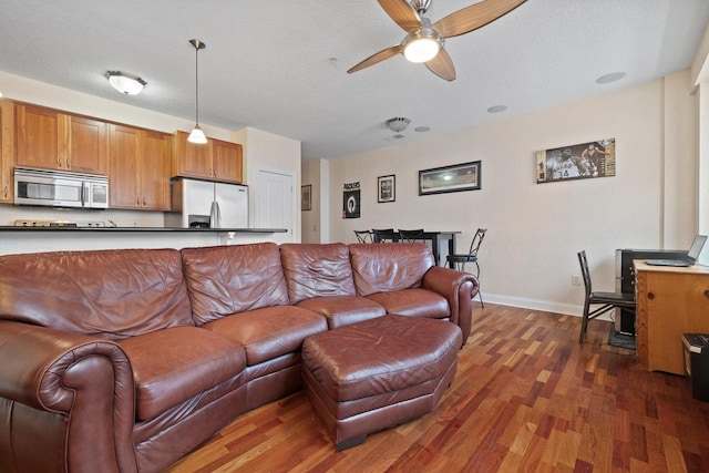 606 W Wisconsin Ave Unit 405, Milwaukee, WI 53203 - living area with dark wood-style flooring, a ceiling fan, and baseboards