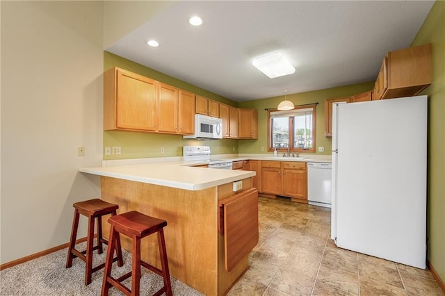 1153 Weather Ridge Rd, Chippewa Falls, WI 54729 - kitchen featuring white appliances, a sink, a peninsula, light countertops, and a kitchen breakfast bar