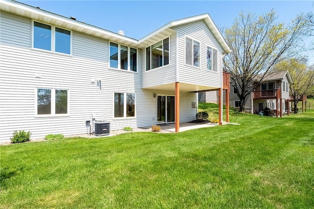 1153 Weather Ridge Rd, Chippewa Falls, WI 54729 - back of property with a patio area, a lawn, and central AC