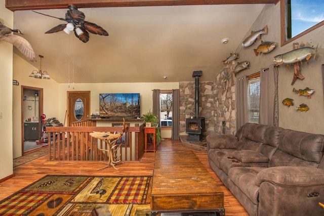 1031 N Osborne Blvd, Racine, WI 53405 - living area featuring wood finished floors, ceiling fan, a wood stove, and high vaulted ceiling