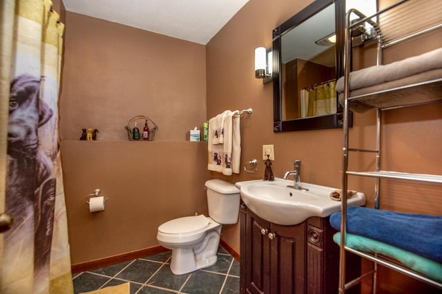 1031 N Osborne Blvd, Racine, WI 53405 - full bath featuring toilet, vanity, baseboards, and tile patterned flooring
