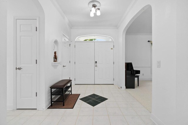 8705 Nelson Xing, Verona, WI 53593 - foyer with arched walkways, crown molding, light tile patterned flooring, and baseboards