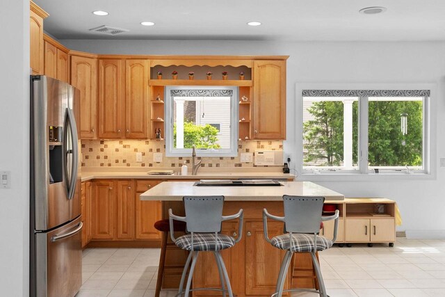 8705 Nelson Xing, Verona, WI 53593 - kitchen with stainless steel fridge, light countertops, open shelves, light tile patterned floors, and decorative backsplash