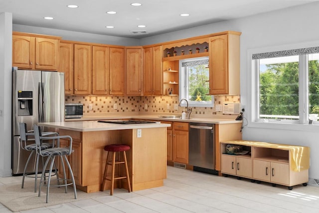 8705 Nelson Xing, Verona, WI 53593 - kitchen featuring stainless steel appliances, a sink, a kitchen island, backsplash, and recessed lighting
