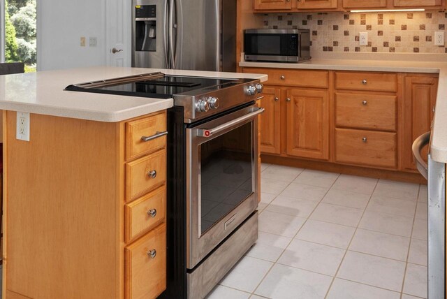 8705 Nelson Xing, Verona, WI 53593 - kitchen with stainless steel appliances, light tile patterned floors, light countertops, tasteful backsplash, and a kitchen island