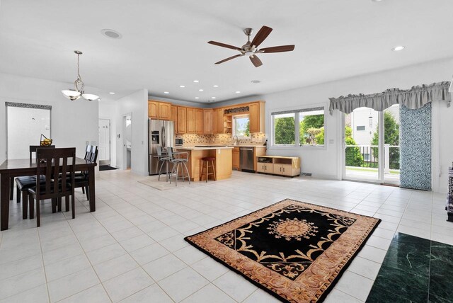 8705 Nelson Xing, Verona, WI 53593 - kitchen with stainless steel appliances, ceiling fan, a chandelier, decorative backsplash, and light tile patterned flooring