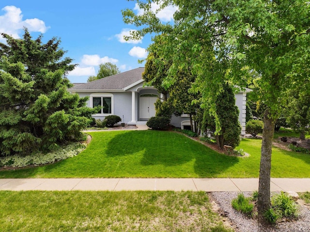 8705 Nelson Xing, Verona, WI 53593 - view of front of home with a front yard, stucco siding, and a shingled roof