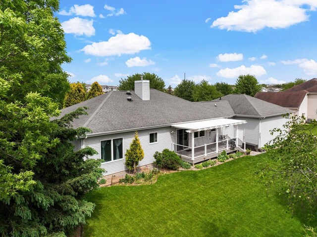 8705 Nelson Xing, Verona, WI 53593 - rear view of property featuring a chimney, a deck, a yard, and a shingled roof
