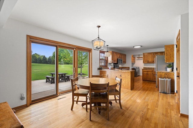 N39W32890 High Hill Ct, Nashotah, WI 53058 - dining room with light wood-type flooring, baseboards, and a chandelier