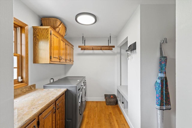 N39W32890 High Hill Ct, Nashotah, WI 53058 - laundry area with separate washer and dryer, cabinet space, light wood-style flooring, and baseboards