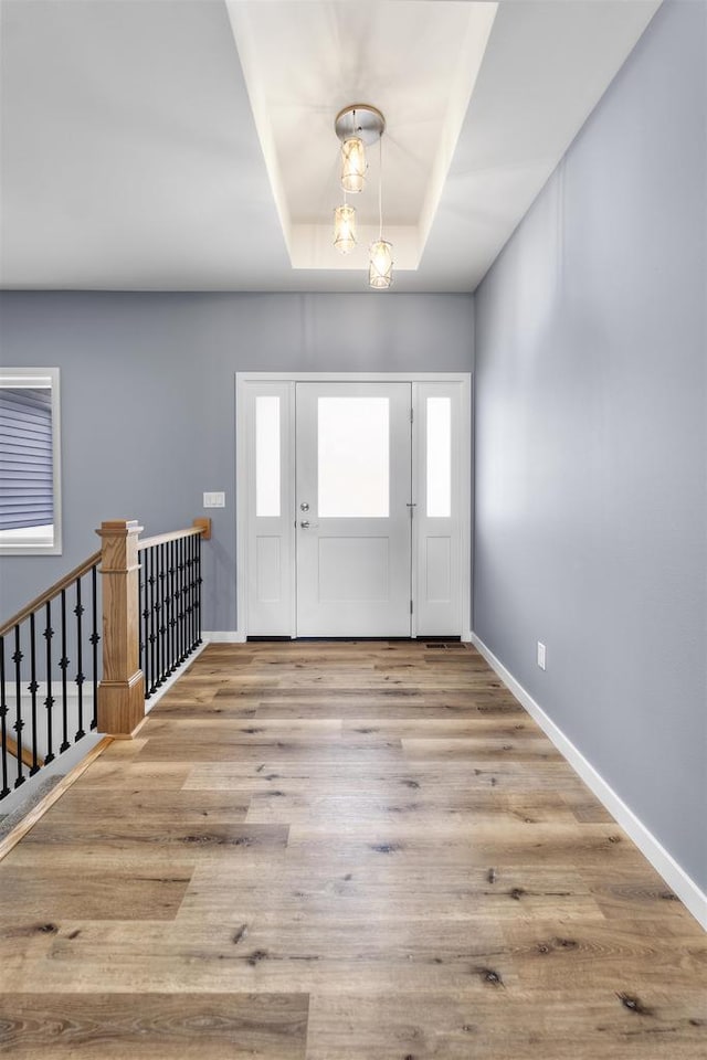 1407 Ridgetrail Dr, Cross Plains, WI 53528 - foyer entrance featuring baseboards, wood finished floors, and a tray ceiling