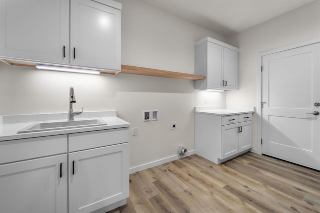 1407 Ridgetrail Dr, Cross Plains, WI 53528 - washroom with electric dryer hookup, hookup for a washing machine, light wood-style flooring, baseboards, and cabinet space