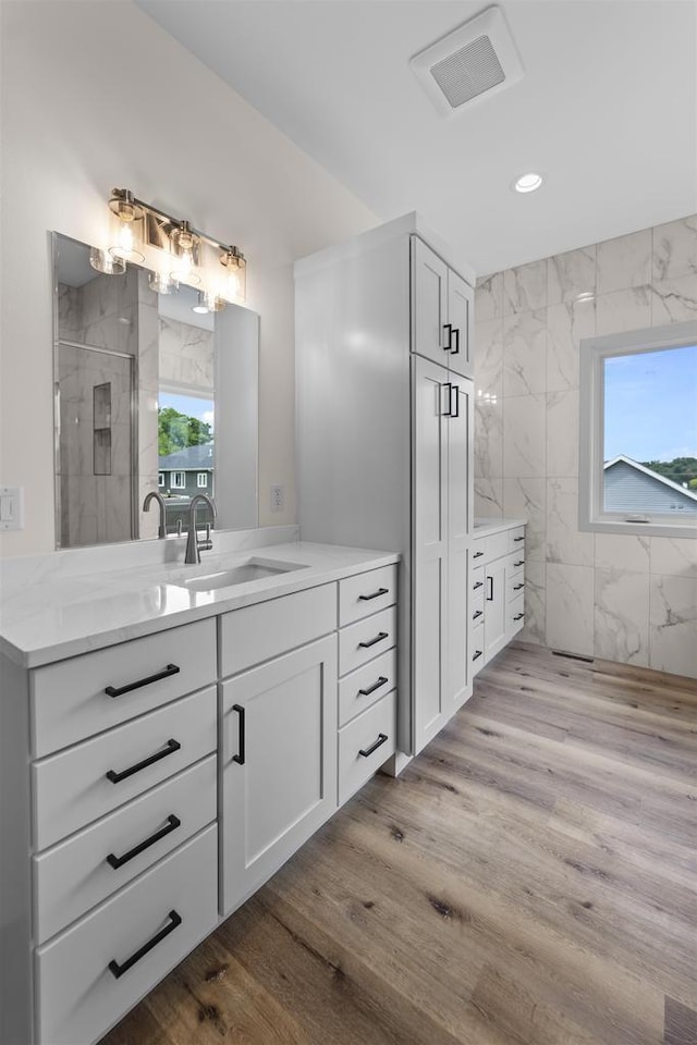 1407 Ridgetrail Dr, Cross Plains, WI 53528 - full bath featuring plenty of natural light, vanity, an enclosed shower, wood finished floors, and recessed lighting