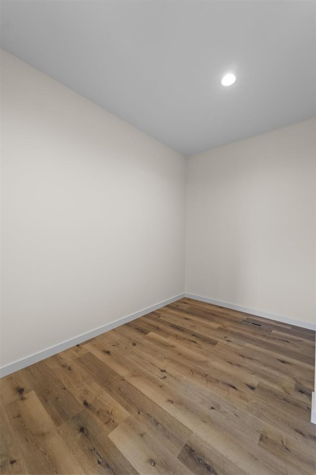 1407 Ridgetrail Dr, Cross Plains, WI 53528 - unfurnished room with wood finished floors, baseboards, and recessed lighting