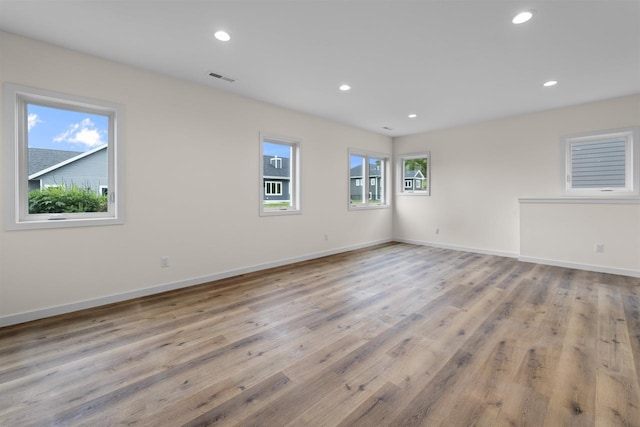1407 Ridgetrail Dr, Cross Plains, WI 53528 - unfurnished room featuring wood finished floors, recessed lighting, and baseboards