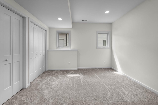 1407 Ridgetrail Dr, Cross Plains, WI 53528 - unfurnished bedroom with carpet flooring, multiple windows, baseboards, recessed lighting, and two closets