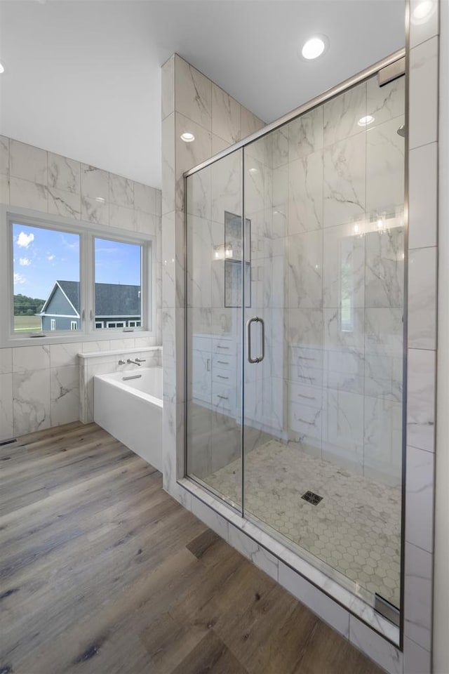 1407 Ridgetrail Dr, Cross Plains, WI 53528 - full bath featuring a garden tub, a stall shower, and wood finished floors