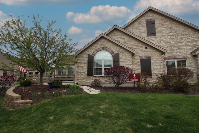 W250N5006 William Dr, Pewaukee, WI 53072 - view of front of home with a front lawn and stone siding