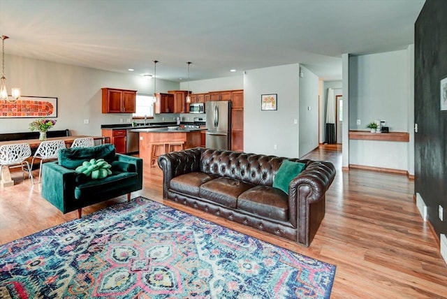6972 Heirloom Dr, Deforest, WI 53532 - living area with a chandelier, light wood-style flooring, baseboards, and recessed lighting