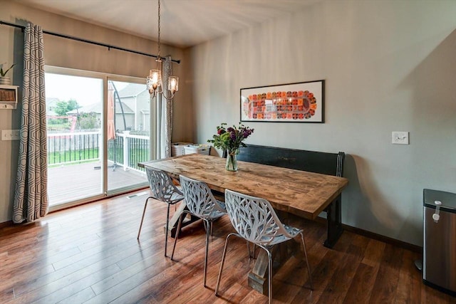 6972 Heirloom Dr, Deforest, WI 53532 - dining area with wood finished floors, a chandelier, and baseboards