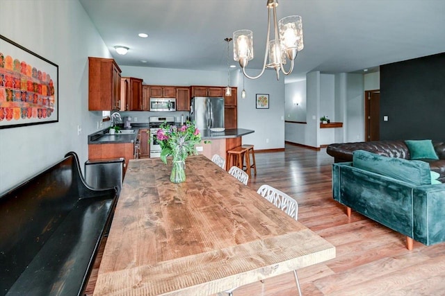 6972 Heirloom Dr, Deforest, WI 53532 - dining room featuring a chandelier, wood finished floors, and baseboards