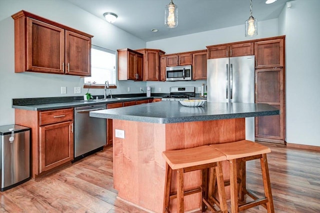 6972 Heirloom Dr, Deforest, WI 53532 - kitchen with appliances with stainless steel finishes, a sink, light wood-type flooring, and dark countertops
