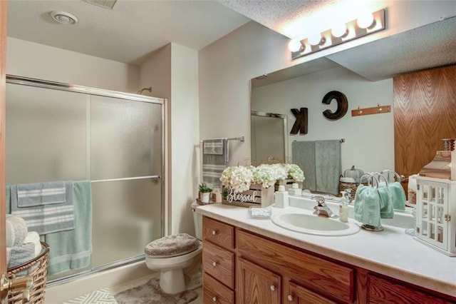 3329 E Meadows Pl, Eau Claire, WI 54701 - bathroom featuring a shower stall, vanity, toilet, and a textured ceiling