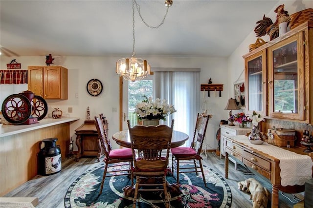 3329 E Meadows Pl, Eau Claire, WI 54701 - dining area with light wood-style floors and a chandelier