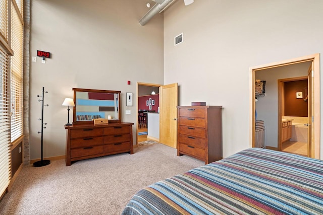 1325 N Van Buren St Unit 308, Milwaukee, WI 53202 - carpeted bedroom featuring a high ceiling, baseboards, and ensuite bathroom